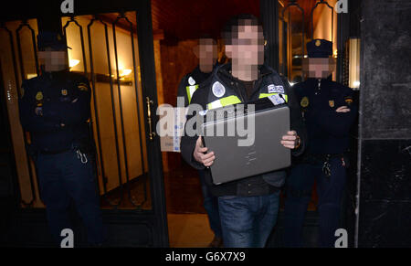 NOTE: IMAGE PIXELATED AT THE REQUEST OF THE POLICE Officers from City of London Police and their Spanish counterparts from the Policia Nacional remove items after raiding a business property in Barcelona, Spain, to execute a warrant in a joint operation as they target a boiler room investment fraud operation. Stock Photo