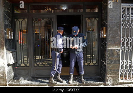 NOTE: IMAGE PIXELATED AT THE REQUEST OF THE POLICE Officers from City of London Police and their Spanish counterparts from the Policia Nacional raid a business property in Barcelona, Spain, to execute a warrant in a joint operation as they target a boiler room investment fraud operation. Stock Photo