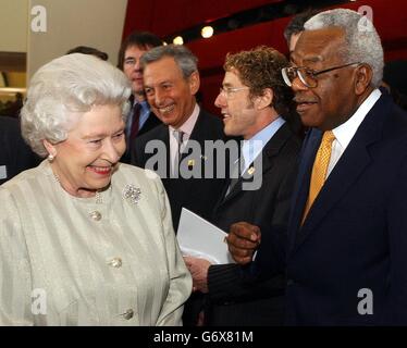 Britain's Queen Elizabeth II shares a joke with television presenter Sir Trevor McDonald during a visit to the Royal Albert Hall in London, marking the end of an 8 year restoration program. The overhaul of one of London's best known landmarks has cost 70 million and includes two new foyers, revamped seating in the stalls and circle as well as better access for disabled patrons. Stock Photo