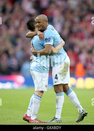 Manchester City's Samir Nasri (left) and Vincent Kompany celebrate winning the Capital One Cup, after the final whistle Stock Photo