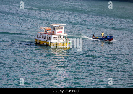 Fishing Boat Passing Ferry in St Lucia Stock Photo