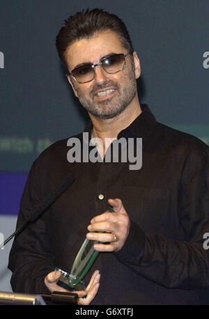 Pop singer George Michael receives the PPL award for the Most Played Artist on British Radio in the last 20 years, at the Shaw Theatre in central London. The star has received more airplay than Robbie Williams, Elton John and Madonna. Songs such as Careless Whisper and Faith have earned him millions of plays on radio stations up and down the country. Now he is being honoured by the Radio Academy for his achievement. Stock Photo