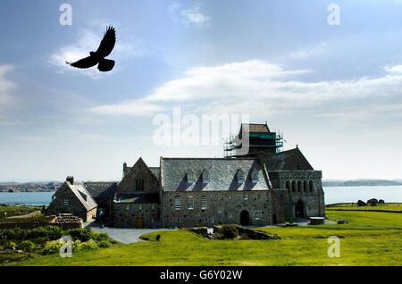 Buildings and Landmarks - Iona Abbey - Scotland. A black raven hovers over Iona Abbey. Stock Photo