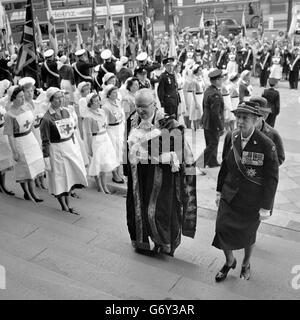 The Princess Royal, the Countess of Limerick, wearing the uniform of the British Red Cross Society Commandant-in-Chief, is escorted by the robed Lord Mayor of London, Sir John Perring, up the steps of St Paul's Cathedral, London, before attending a service commemorating the centenary of the Red Cross. In the background, Red Cross nurses formed a guard of honour on the steps. Stock Photo