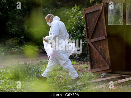 Police investigator carries an evidence bag at the home of Peaches Geldof in Wrotham, Kent, after the 25-year-old was found dead at home yesterday afternoon. Stock Photo