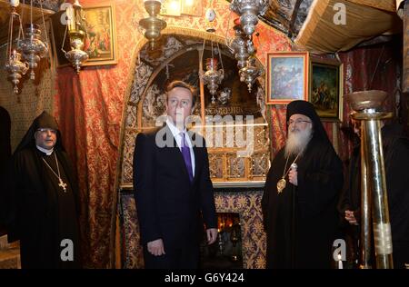 Prime Minister David Cameron (centre) during a visit to the Church of the Nativity in Bethlehem, on the second day of a trip to the Middle East designed to bolster efforts to rekindle the stalled peace process. Stock Photo