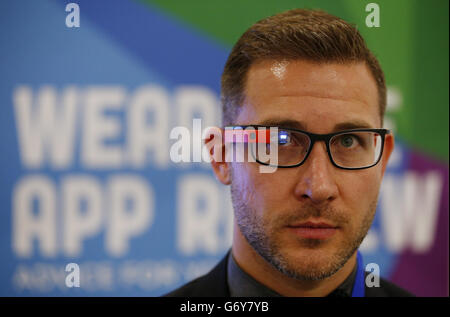 An exhibitor demonstrates Google Glass at the Wearable Technology Show held at Kensington Olympia, London. Stock Photo