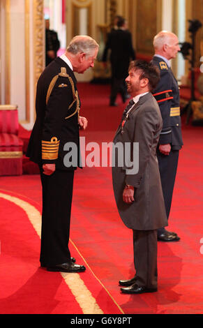 Basil Newby from Poulton-Le-Fylde is made a Member of the Order of the British Empire (MBE) by the Prince of Wales during an Investiture ceremony at Buckingham Palace, central London. Stock Photo