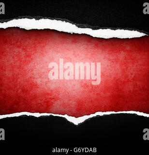 Hole ripped in paper on red background Stock Photo