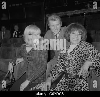 Sylvie Vartan, France's Queen of Pop, and her husband, singer Johnny Hallyday talk with Britain's Shirley Bassey (r) at the London Palladium, where they were taking part in rehearsals for the Royal Variety Performance. Sylvie, Little Miss Ye-Ye to her fans, was married to Johnny seven months ago. Stock Photo