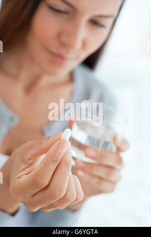 MODEL RELEASED. Young woman taking medicine. Stock Photo