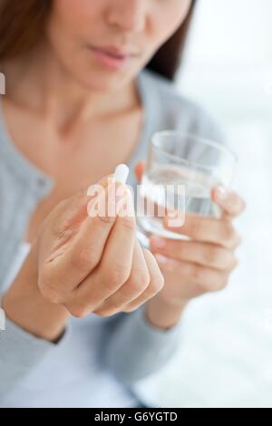 MODEL RELEASED. Young woman taking medicine. Stock Photo