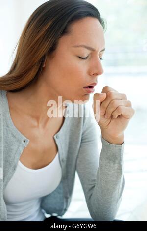 MODEL RELEASED. Young woman coughing. Stock Photo
