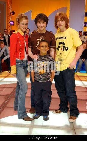 Harry Potter stars Emma Watson, Daniel Radcliffe and Rupert Grint with a fan during their guest appearance on MTV TRL UK at the MTV Studios's in Camden. Stock Photo