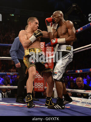 Scott Quigg (left) in action against and Tshifhiwa Munyai during the WBA World Super Bantamweight Title bout at the Phones 4U Arena, Manchester. Stock Photo