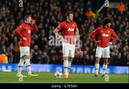 Manchester United's Marouane Fellaini (right), Michael Carrick (centre) and Wayne Rooney (left) appear dejected after Bayern Munich's Bastian Schweinsteiger (not in picture) scored his team's opening goal