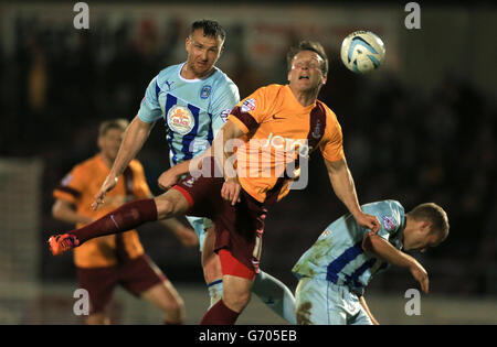 Soccer - Sky Bet League One - Coventry City v Bradford City - Sixfields Stadium. Coventry City's Andrew Webster wins header beating Bradford City's Garry Thompson Stock Photo