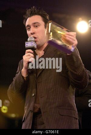 XFM DJ Christian O'Connell accepting his DJ of the Year Award on stage during the Sony Radio Academy Awards 2004, held at Grosvenor House hotel on Park Lane, London. The ceremony saw Jonathan Ross and Radio 1's Chris Moyles lose out to Xfm's Christian O'Connell, who was named DJ of the Year. Stock Photo