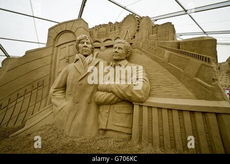 A massive sculpture of the lead characters from TV series Sherlock with a London skyline at Sandworld in Weymouth, where the seaside attraction will be open for the British summer season to the general public on Saturday April 5th 2014. Stock Photo