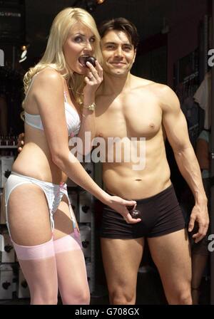 Models Nancy Sorrell, celebrity face of Ann Summers, and Marco during the launch of the 'Check his Plums' campaign at Ann Summers in Oxford Street, central London. The campaign aims to raise money and awareness for testicular cancer, in partnership with the cancer charity Everyman. Stock Photo