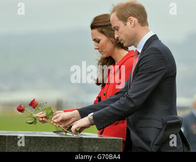 The Duke and Duchess of Cambridge lay roses as they view the RNZAF Memorial Wall at Wigram Air Force Base, Christchurch during the eighth day of their official tour to New Zealand. Stock Photo