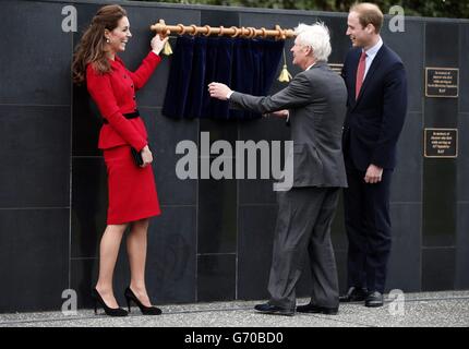 The Duke and Duchess of Cambridge, laugh as the cord they were pulling to unveil a plaque failed during a visit to the Royal New Zealand Air Force memorial wall at the air force museum in Christchurch April 14, 2014. The royal couple are undertaking a 19-day official visit to New Zealand and Australia with their son, Prince George. Stock Photo