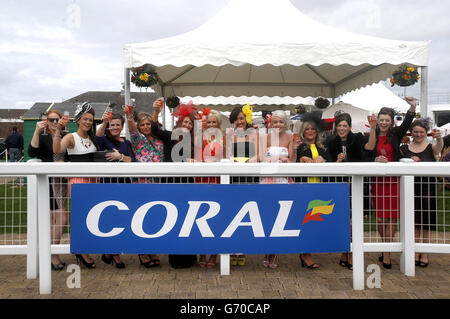 Horse Racing - Coral Scottish Grand National - Day One - Ayr Racecourse. Racegoers by the parade ring at Ayr Racecourse. Stock Photo