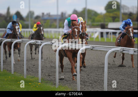 Escalating ridden by James Doyle wins the Betfed TV / British Stallion Studs EBF Maiden Stakes during the Easter Family Fun Day at Kempton Park Racecourse. Stock Photo