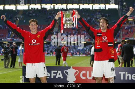 Manchester United's goal scorers Cristiano Ronaldo and Ruud van Nistelrooy (R) lift the trophy at the end of the FA Cup Final against Millwall at the Millennium Stadium, Cardiff. Stock Photo