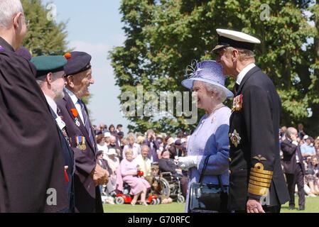 Britain's Queen Elizabeth II and her husband the Duke of Edinburgh meets British war veterans at the Commonwealth War Graves Cemetery in Bayeux, northern France. World leaders and thousands of veterans have gathered to commemorate the 60th anniversary of D-Day in Normandy. Stock Photo