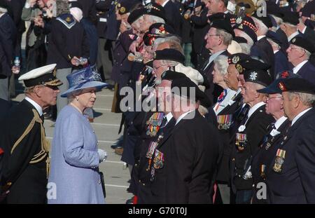 Britain's Queen Elizabeth II and the Duke of Edinburgh talk to D-Day veterans during a D-Day 60th Anniversary March held in Arromanches in Normandy in northern France. Her Majesty was joined by British Prime Minister Tony Blair and thousands of WW II veterans. Stock Photo