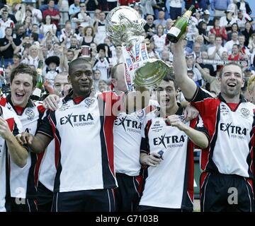 Hednesford Town captain Steve Anthrobus holds the FA Trophy as he leads the celebrations after the FA Trophy Final against Canvey Island at Villa Park, Birmingham. NO UNOFFICIAL CLUB WEBSITE USE. Stock Photo