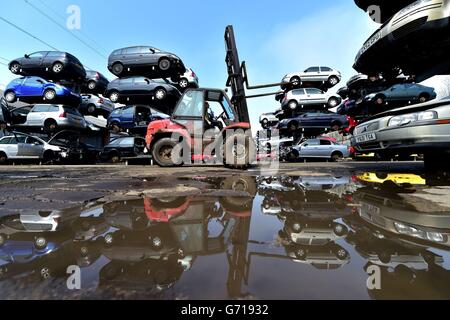 A worker at the UK's largest car dismantlers, Motor Hog in North Shields, Tyneside, which has bought specialist dismantling and de-polluting equipment capable of handling over 200 vehicles per day and crushing hundreds of thousands a year. Stock Photo