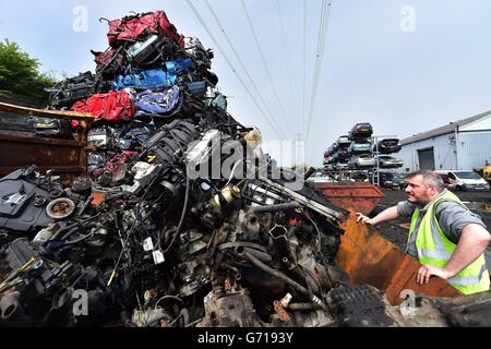 A worker at the UK's largest car dismantlers, Motor Hog in North Shields, Tyneside, which has bought specialist dismantling and de-polluting equipment capable of handling over 200 vehicles per day and crushing hundreds of thousands a year. Stock Photo