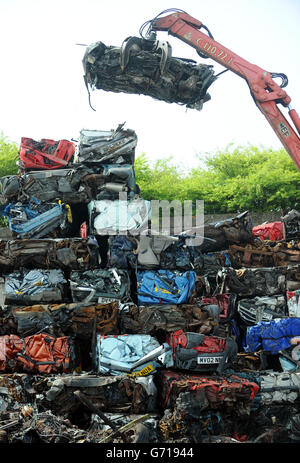 A car is crushed at the UK's largest car dismantlers, Motor Hog in North Shields, Tyneside, which has bought specialist dismantling and de-polluting equipment capable of handling over 200 vehicles per day and crushing hundreds of thousands a year. Stock Photo