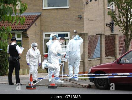 Forensic officers at the property in Camblesforth, near Selby, North Yorkshire where two bodies were found. Stock Photo
