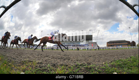 Zurigha ridden by Ryan Moore wins the Betfred Mobile Lotto Snowdrop Fillies' Stakes during the Easter Family Fun Day at Kempton Park Racecourse. Stock Photo