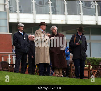 Trainer John Gosden (centre left) watches Western Hymn ridden by William Buick win the bet365 Classic Trial during Bet365 Friday at Sandown Park, Sandown. Stock Photo