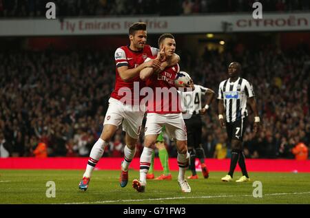 Arsenal's Laurent Koscielny celebrates scoring his side's first goal of the game with teammate Olivier Giroud (left) Stock Photo