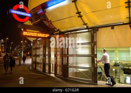 A member of staff closes shutters at Southwark underground station, in central London, at the start of 48 hours of industrial action by RMT union members affecting the London Underground in a row over ticket office closures. Stock Photo