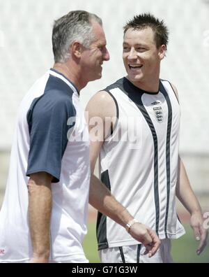 England defender John Terry walks off the pitch with coach Ray Clemence before an England training session at the National Stadium in Lisbon, in preparation for the opening Euro 2004 match against France this Sunday. , NO MOBILE PHONE OR PDA USE. INTERNET USE ONLY ON UEFA AUTHORISED SITES. Stock Photo