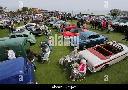 A couple enjoy the fine weather at the back of their classic car in Eastbourne, Sussex, during the second day of Magnificent Motors, as around 600 vintage and classic vehicles take part in the largest free motoring spectacular on the south coast. Stock Photo