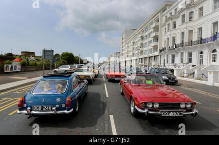 Classic cars are driven along the seafront in Eastbourne, Sussex, at the start of the second day of Magnificent Motors, as around 600 vintage and classic vehicles take part in the largest free motoring spectacular on the south coast. Stock Photo