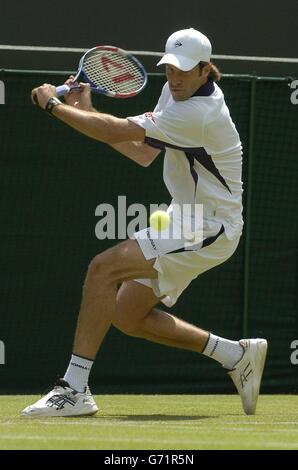 Great Britain's Greg Rusedski in action against Rainer Schuettler from Germany at The Lawn Tennis Championships in Wimbledon, London. Stock Photo
