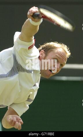 Rainer Schuettler from Germany in action against Great Britain's Greg Rusedski at The Lawn Tennis Championships in Wimbledon, London. Schuettler defeated Britain's number two in five sets 6:7/7:6/6:7/6:2/6:2. , NO MOBILE PHONE USE. Stock Photo