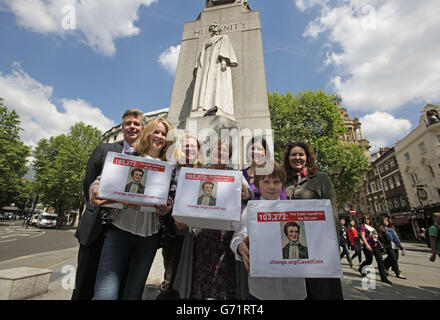 Nurses and family of World War I nurse Edith Cavell (left to right) Robert Tunmore, Pip Smith, Helen Peyton, Sheffield City Councillor Sioned-Mair Richards (who started the petition), Rosanne Kirk, Kit Smith and Jane Peyton by her statue in St Martin's Place, London, before delivering a 100,000 strong petition at HM Treasury calling for her to be commemorated on a &pound;2 coin to mark the Great War's centenary. Stock Photo