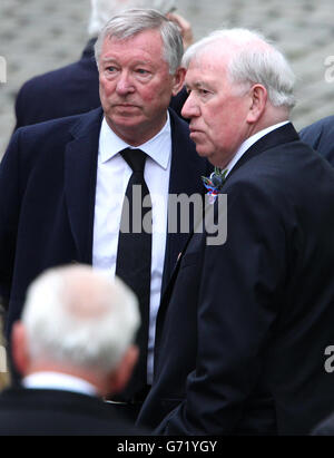 Sir Alex Ferguson with John Greig as they attend the funeral of ex Rangers footballer Sandy Jardine at Mortonhall crematorium in Edinburgh. Stock Photo