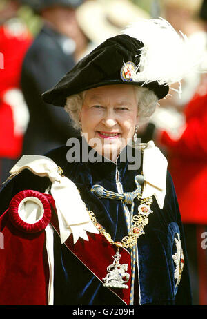 Queen Elizabeth II walks through the grounds of Windsor Castle, Berkshire, on her way to the annual ceremony of the Order of the Garter, in an open top carriage. Stock Photo