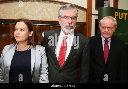Sinn Fein president Gerry Adams (centre) with Sinn Fein deputy leader Mary Lou McDonald and Northern Ireland Deputy First Minister Martin McGuinness as he arrives for a press conference in the Balmoral Hotel, Belfast, after his release from custody at Antrim Police Station following questioning in connection with the murder of mother-of-10 Jean McConville in 1972. Stock Photo