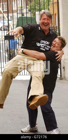 Ground Force presenter Tommy Walsh is lifted by Heart FM DJ Jono Coleman during a photocall to celebrate their winning the Epsom Celebrity Dad of the Year 2004, outside the Grovesnor House Hotel in central London. Stock Photo